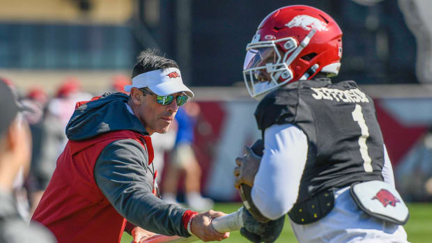 Arkansas Razorbacks offensive coordinator Dan Enos with quarterback KJ Jefferson during Tuesday afternoon's practice.
